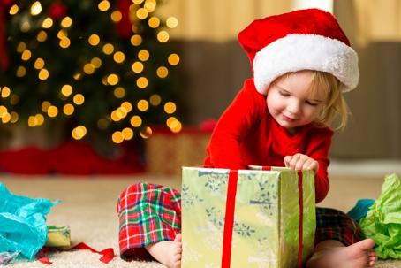 little girl opening Christmas present