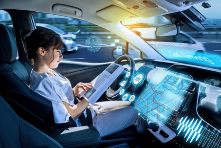 young woman reading in self driving car