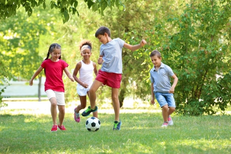 children playing soccer during summer