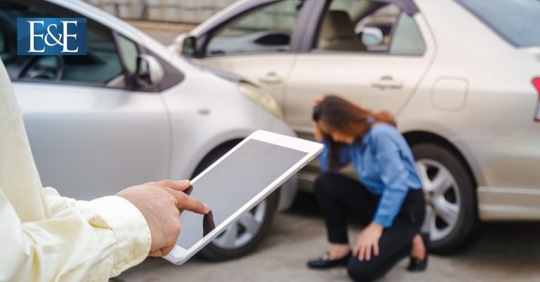 person documenting a car accident